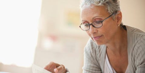 Older woman reading with glasses