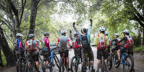 muddy women on mountain bikes after a ride