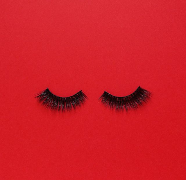 artificial eyelashes on red background