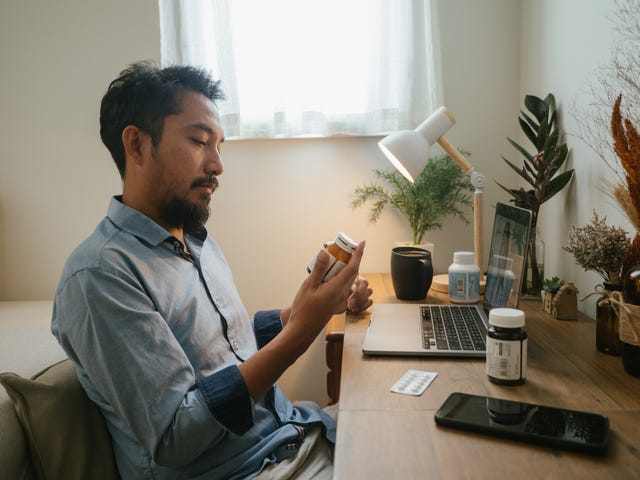 Asian man a video telemedicine call with a doctor. asian man a video telemedicine call with a doctor