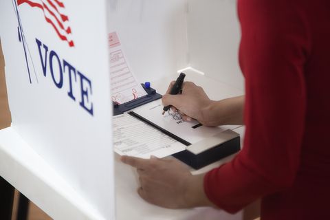 asian voter voting in polling place
