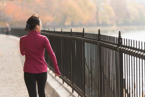 Asian woman running on waterfront path asian woman running on waterfront path