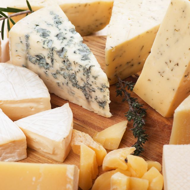 assorted cheese on wooden platter