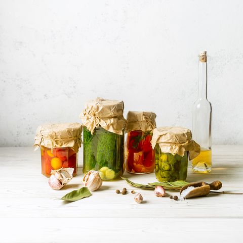 assorted homemade vegetable preserves in glass jars