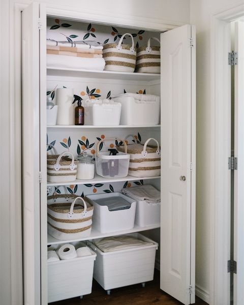 linen closet organization with an assortment of storage containers