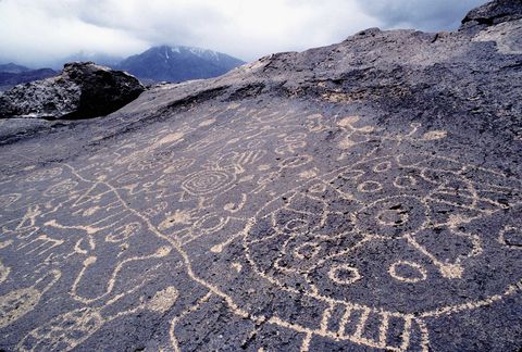 Petroglyphs of Paiute or Shoshone origin near the Owens Valley in the Eastern Sierra, carved from volcanic tuff by removing the dark top layer and exposing a light surface below