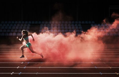athlete running in red smoke