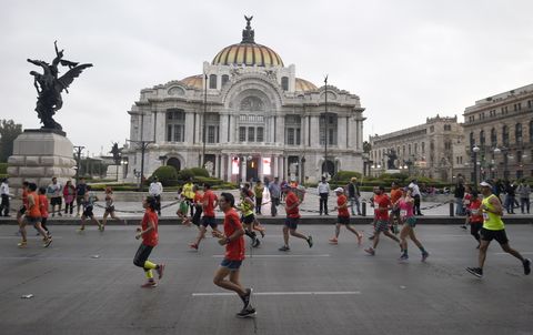 Corredores corriendo en el Maratón de México ante el Palacio de Bellas Artes
