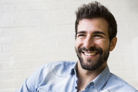 Portrait of laughing young man with beard