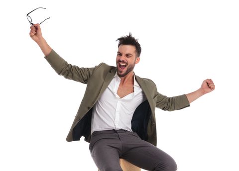 excited elegant man celebrating while looking to side