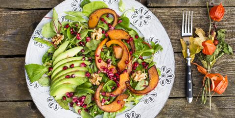 autumnal salad with squash, pomegranate seeds, avocado and walnuts