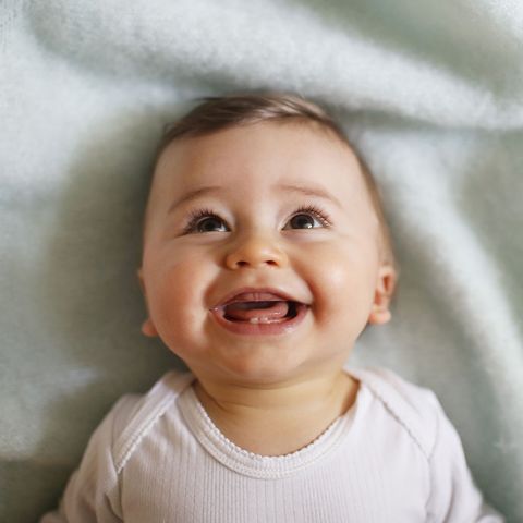 Portrait of a 8 months old baby boy smiling