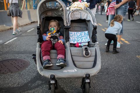 baby in a stroller celebrates biden 2020 win