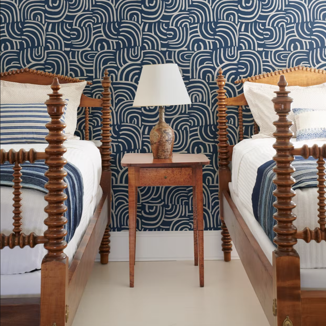 twin beds with blue wallpaper