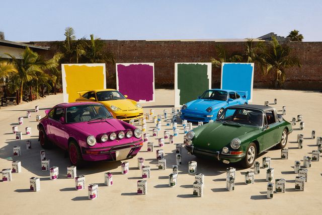 a group of classic porsche cars with backdrop paint