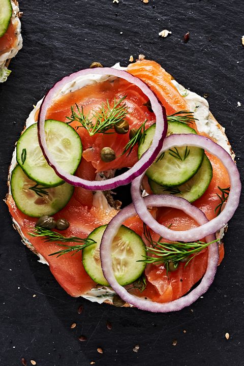 bagel and lox topped with tomato, cucumber, capers and onion