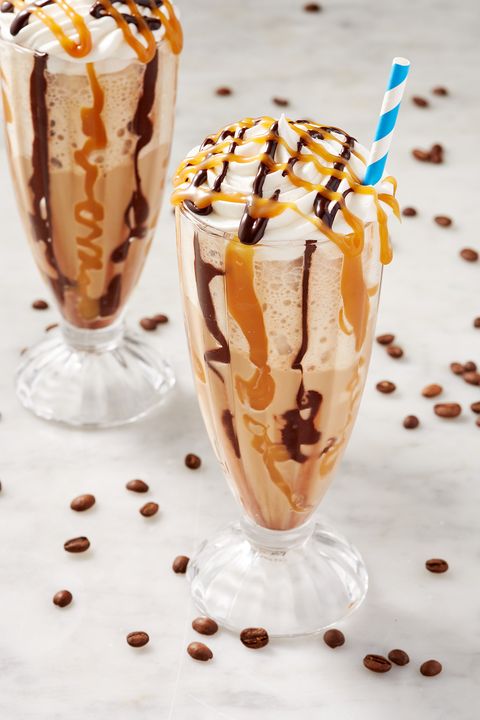 glass of baileys irish cream coffee slushie topped with whipped cream, chocolate syrup, and caramel