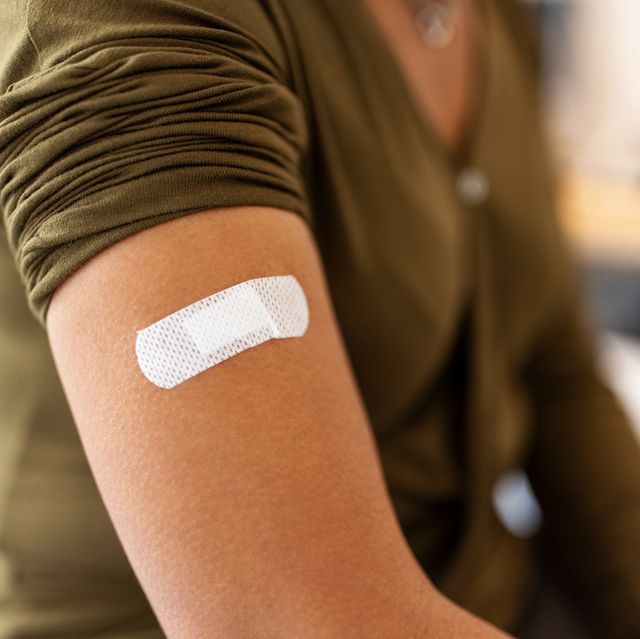 bandage on arm of a female after taking vaccine