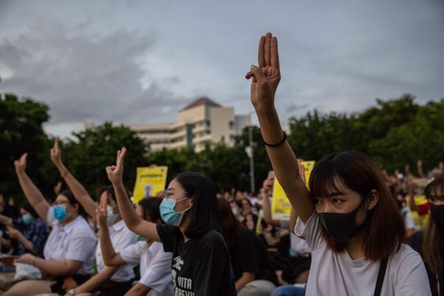 bangkok, thailand   august 10  thai people hold up a three finger salute at an anti government protest on august 10, 2020 at thammasat university in bangkok, thailand approximately 3,000 anti government protesters attended the rally that is the latest in a string of daily protests, started by students in late july student organizations have been calling for the dissolution of thailands military backed government led by prime minister prayut chan o cha photo by lauren deciccagetty images
