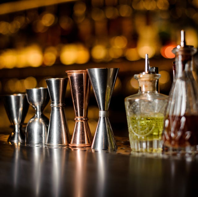 Barman equipment such as measuring cups and essence on the bar counter