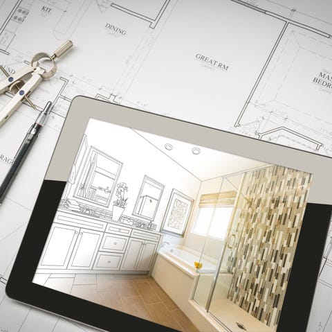 computer tablet with master bathroom design over house plans, pencil and compass