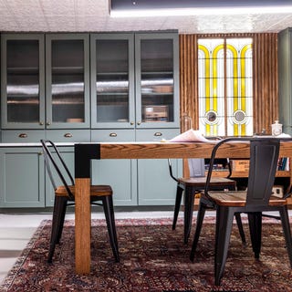 speakeasy, wooden table with black iron dining chairs, green storage cupboards