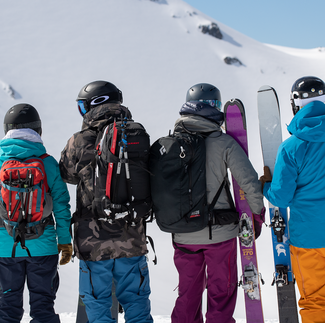 snowboarders on snowy mountain with backcountry gear