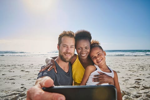 family taking self portrait on beach