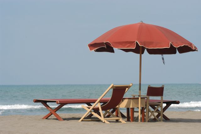 beach umbrella with deckchairs