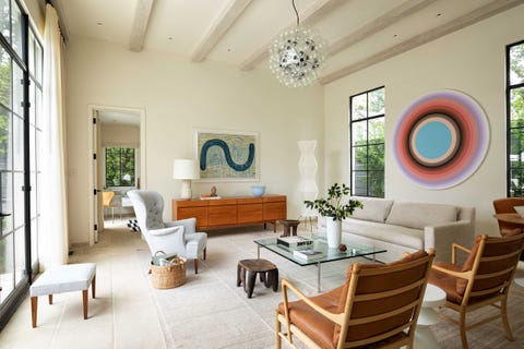 living room, cream painted walls, wooden ceiling beams, wooden side board, cream sofa couch, artwork