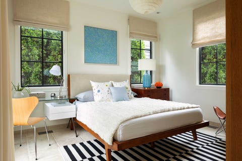 bedroom, white cream painted walls, tan curtains, black and white stripped rug, views of exterior trees