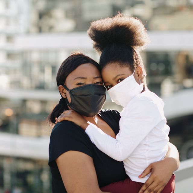 during the covid 19 pandemic a mother and daughter wear face masks