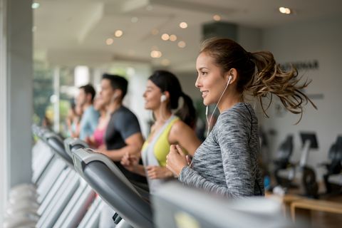 Beautiful woman exercising at the gym running on a treadmill