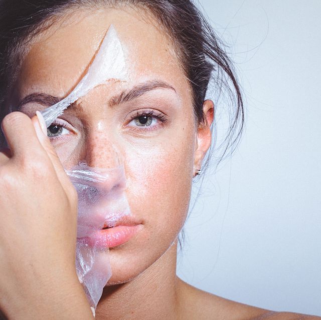 beauty portrait of a young woman applying removing face mask
