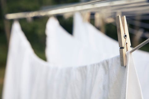 bed sheets drying on clotheslines