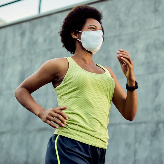 below view of black female runner with protective face mask