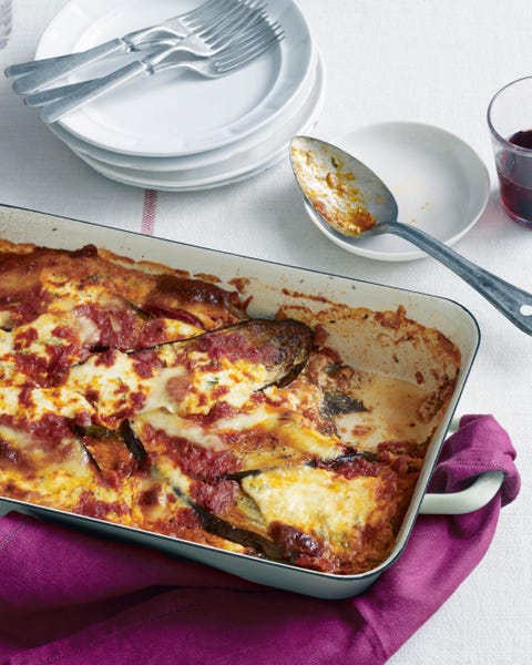 a dish of eggplant lasagna without noodles with a serving spoon on a small plate near by