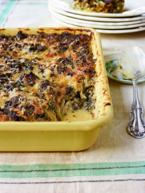 creamed kale gratin in a yellow baking dish with a scoop taken out