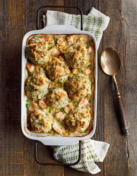 shrimp chowder with herb drop biscuits on top in a rectangle white baking dish