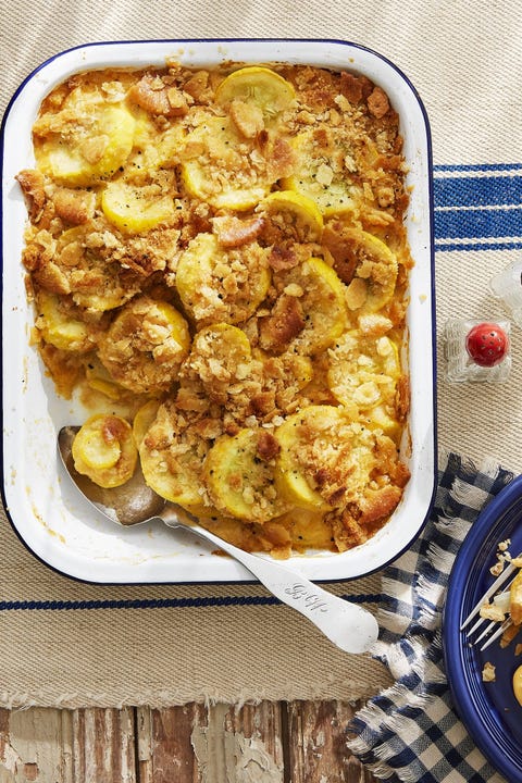 squash casserole in a white baking dish with a spoon