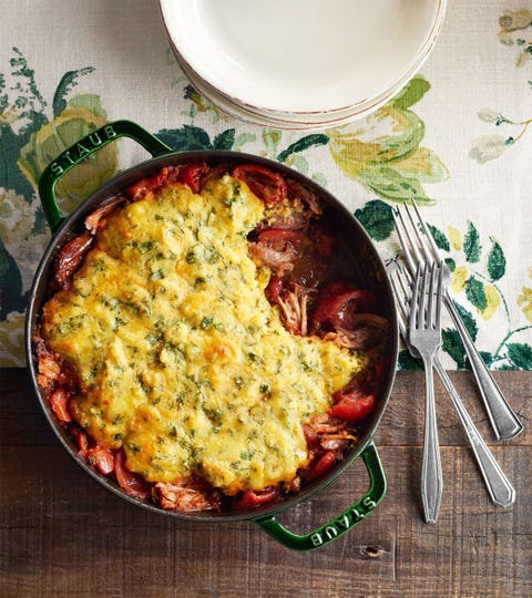 pork tamale pie in a dark green round cast iron pan