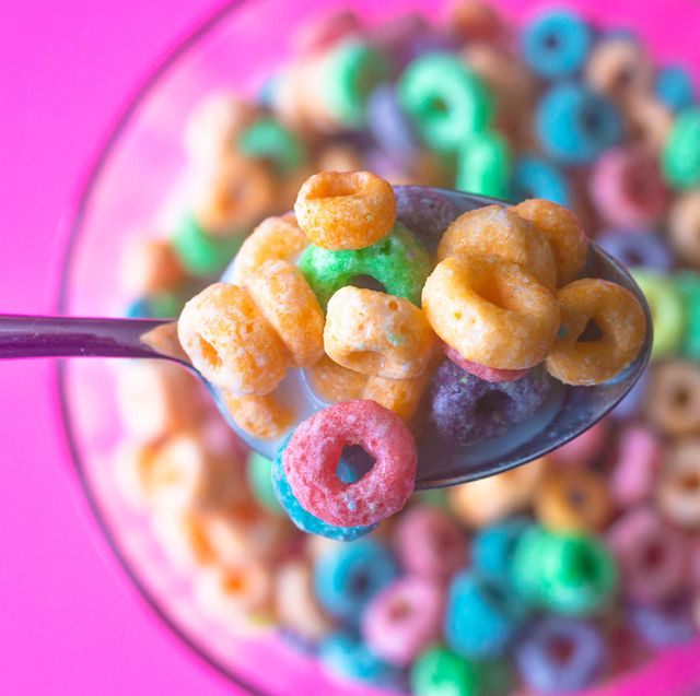 fruity cereal on a spoon above a bowl