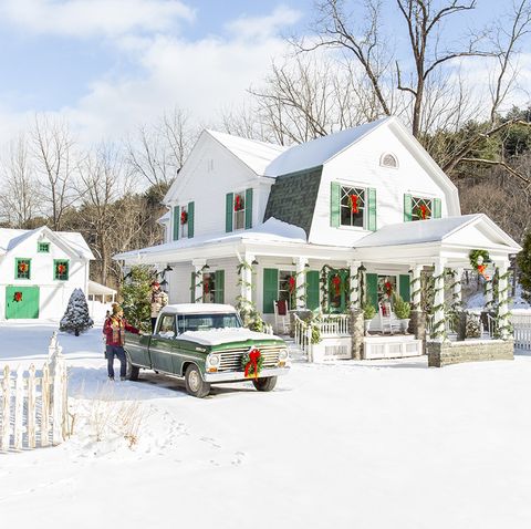 white farmhouse exterior with garland