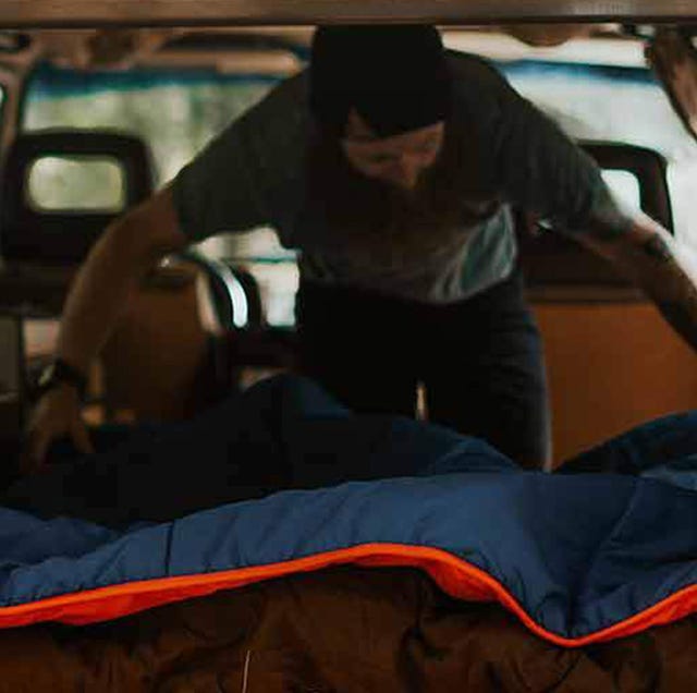man setting up ignik heated blanket in car