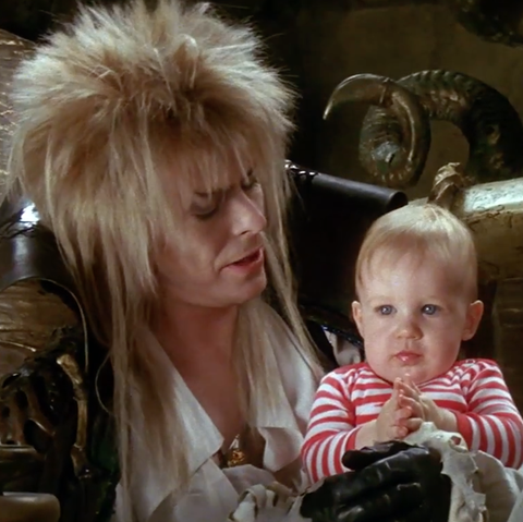 david bowie, as jareth the goblin king, holds baby toby in a scene from &qu...
