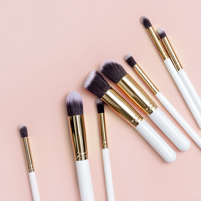 Various Make-Up Brushes On Pink Background