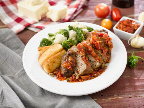 meatloaf with vegetables on a white plate and wooden table from bistromd, a good housekeeping 2022 best meal delivery service