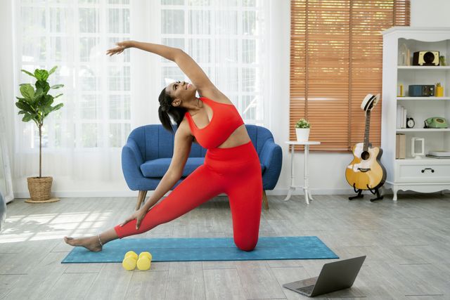 woman doing yoga video in home