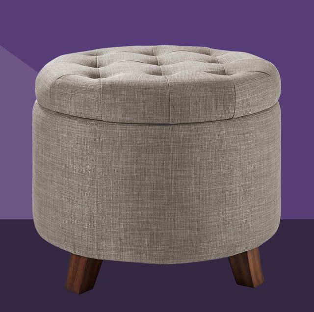 a grey upholstered tufted storage ottoman footstool against a purple background