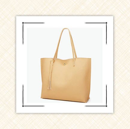 beige shoulder bag and two large black planters beige shoulder bag and two large black planters